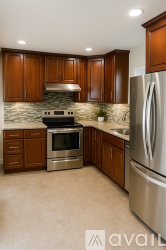 A kitchen with wooden cabinets and stainless steel appliances.