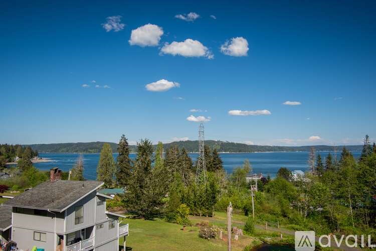 A house with a view of a lake and trees.