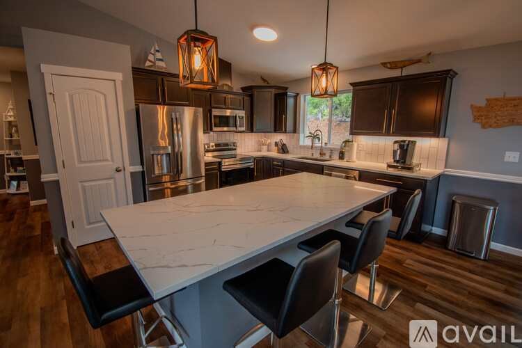 A kitchen with a large island and modern appliances.