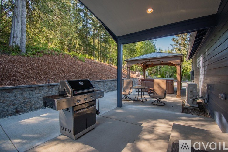 A backyard with a grill and picnic table.