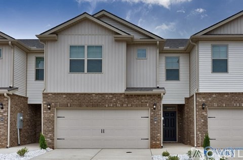 A row of houses with garages in front.