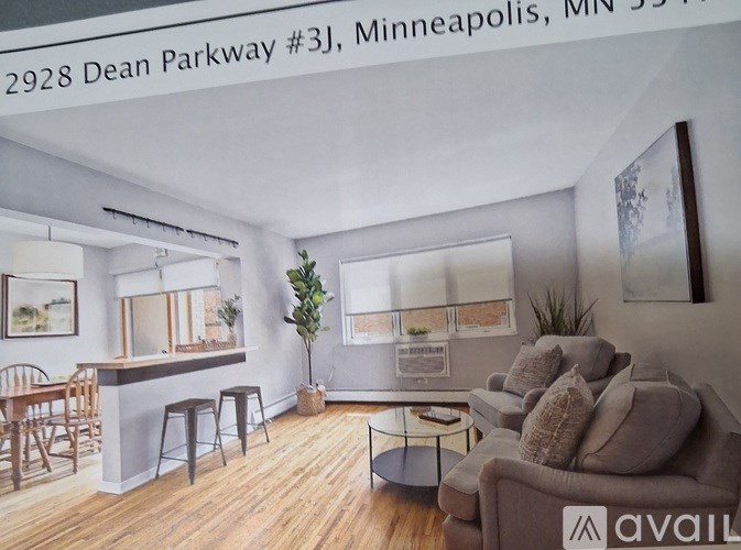 A living room with a couch, chairs, and a bar area.
