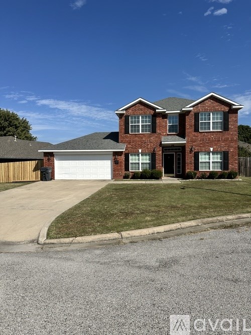 A two-story brick house with a garage.