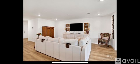 A living room with a white couch and a wooden door.