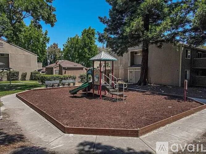 A playground with a slide and a green slide in the middle.