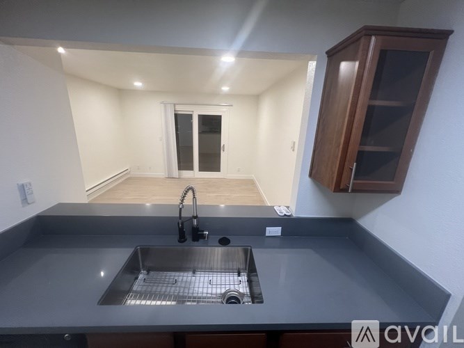 A kitchen with a sink and a cabinet.