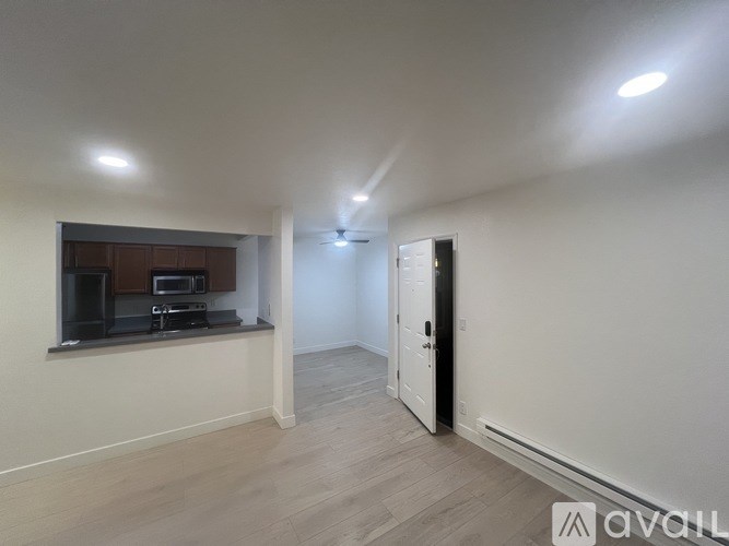 A spacious room with a door on the right side.