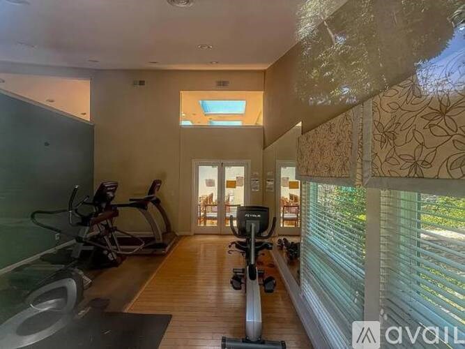 A well-lit room with exercise equipment and a view of the outdoors.