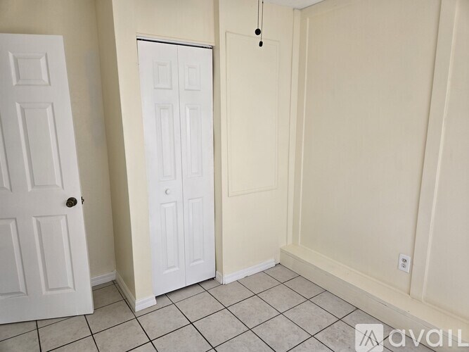 A room with a white door and a white closet.