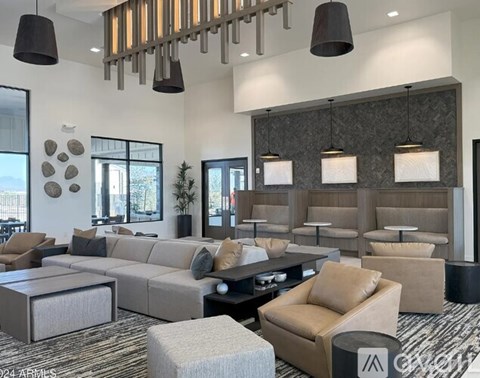 A modern living room with a grey sofa set and a wooden coffee table.