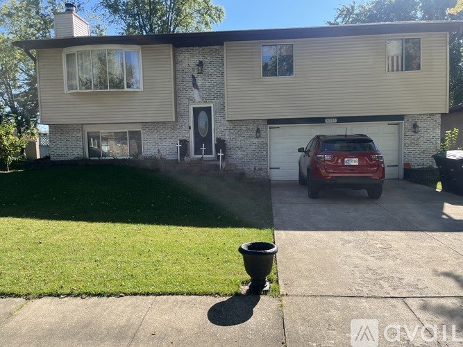 A red car is parked in the garage of a house.