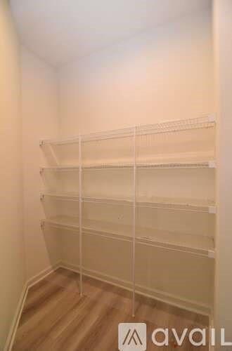 Empty shelves in a room with wooden flooring.