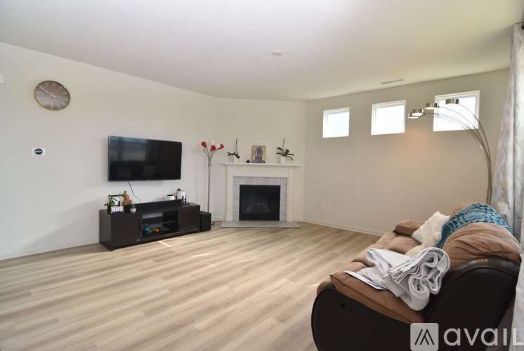 A living room with a fireplace and a television.