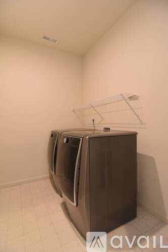 A large brown appliance with a white top is in a room with white walls.