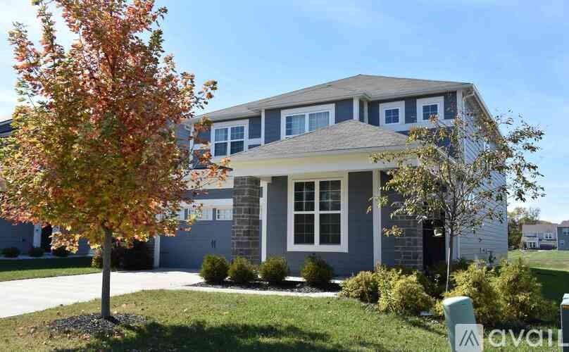 A house with a tree in front of it.