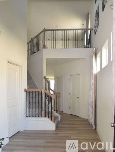 A staircase with a metal railing and wooden steps.