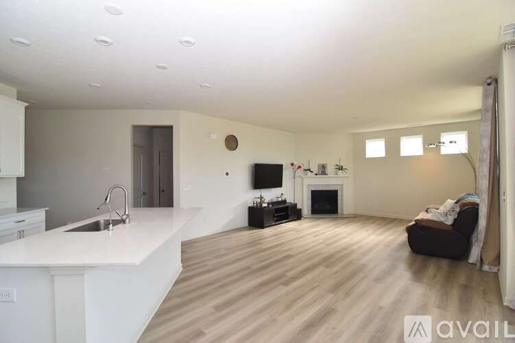 A spacious living room with a fireplace and a television.