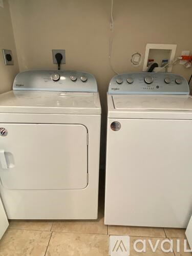 Two front loading washing machines in a laundry room.