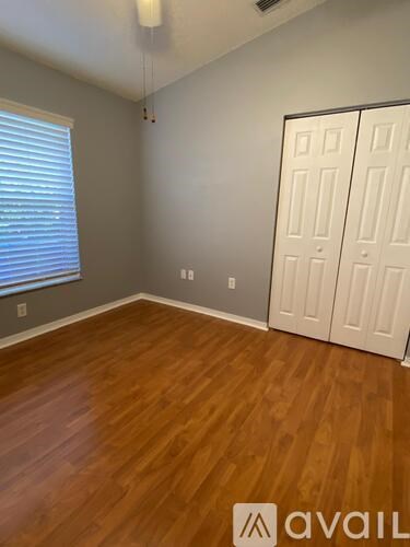 A room with wooden floors and a white door.