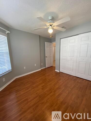 A room with a ceiling fan and a light bulb.