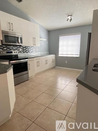 A kitchen with a stove top oven and a microwave.