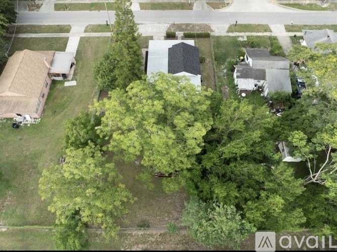 A bird's eye view of a residential area with houses and trees.