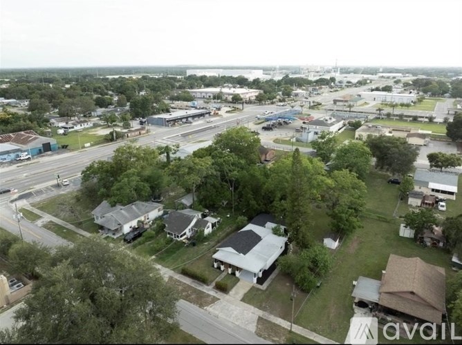 A bird's eye view of a residential area with houses and a road.