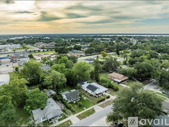 A bird's eye view of a residential neighborhood with houses and trees.