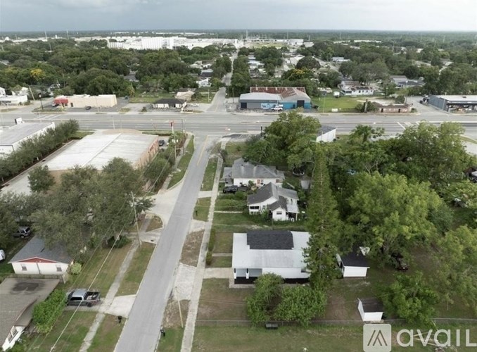 An aerial view of a small town with a mix of residential and commercial buildings.