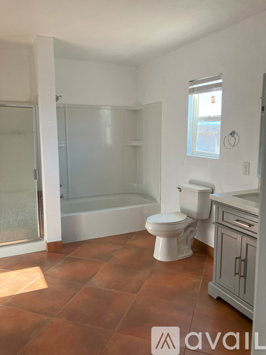 A bathroom with a toilet, sink, and bathtub.