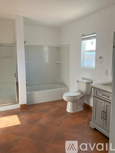 A bathroom with a toilet, sink, and bathtub.