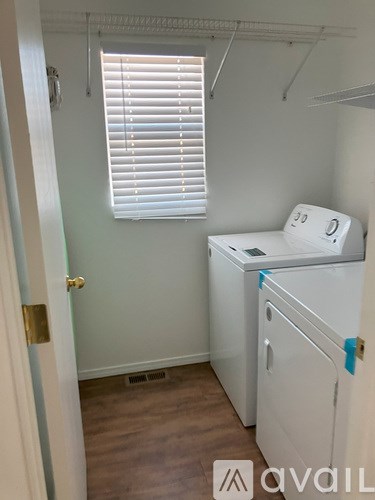 A small laundry room with a washer and dryer.