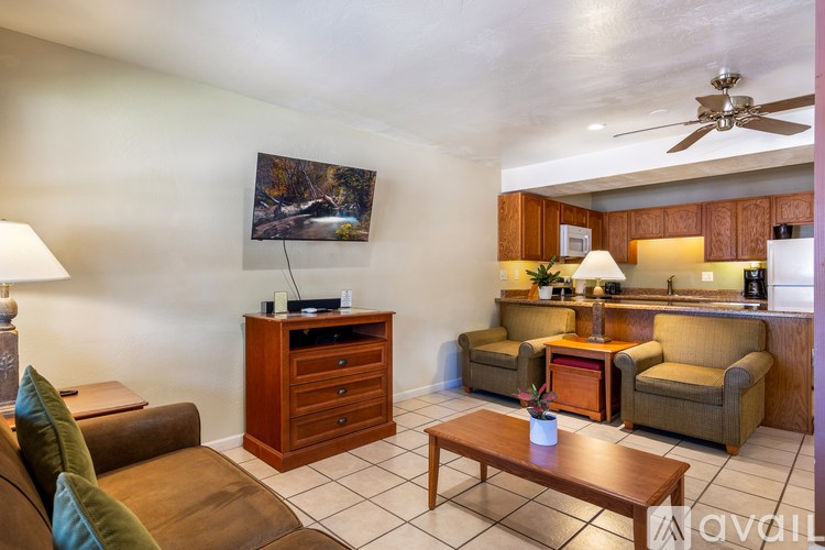 A living room with a brown couch and a wooden coffee table.