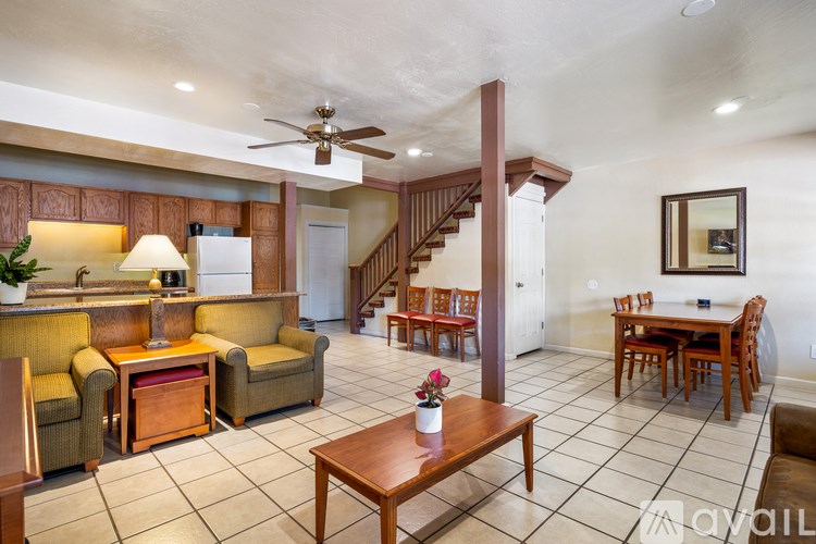 A living room with a staircase in the background.