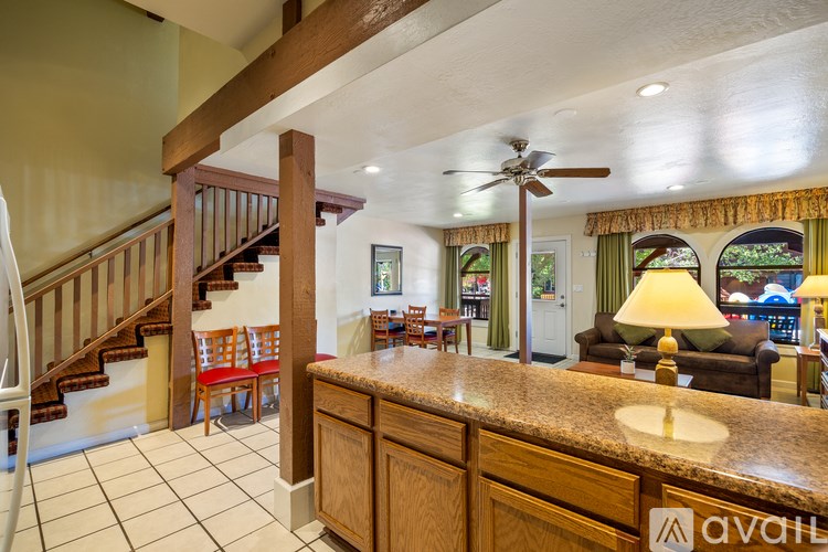 A well-lit lobby with a staircase and a counter.