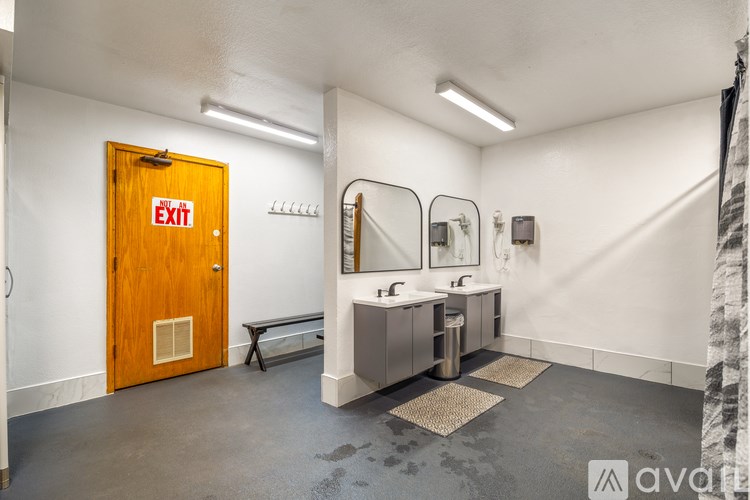 A bathroom with a wooden exit door and a bench.