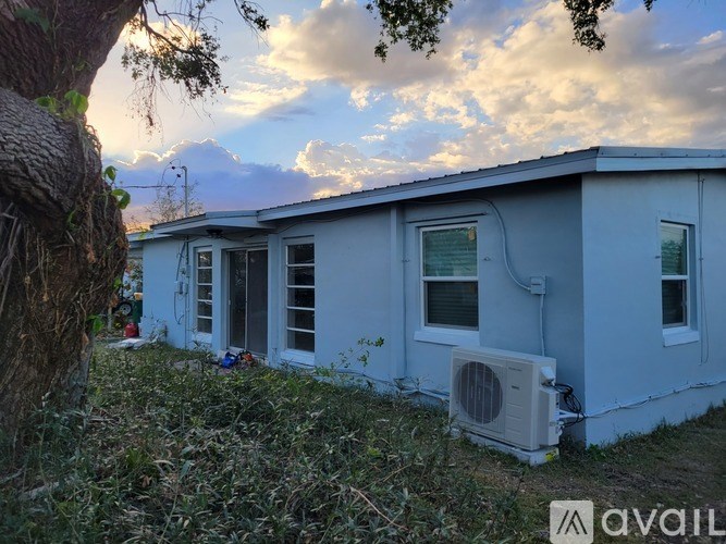 A house with a tree in front of it.