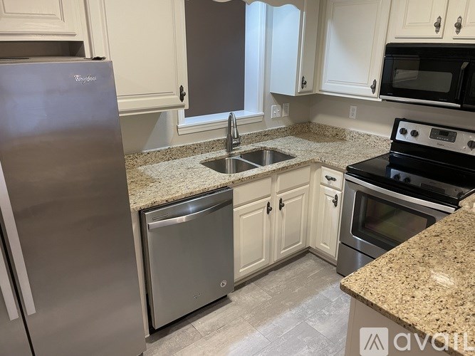 A kitchen with granite countertops and stainless steel appliances.