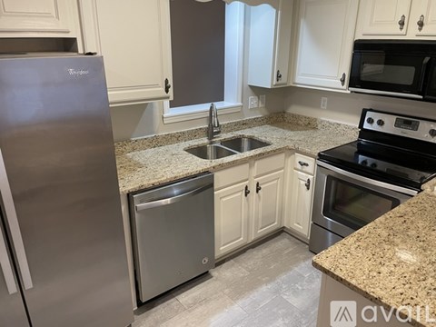 A kitchen with granite countertops and stainless steel appliances.
