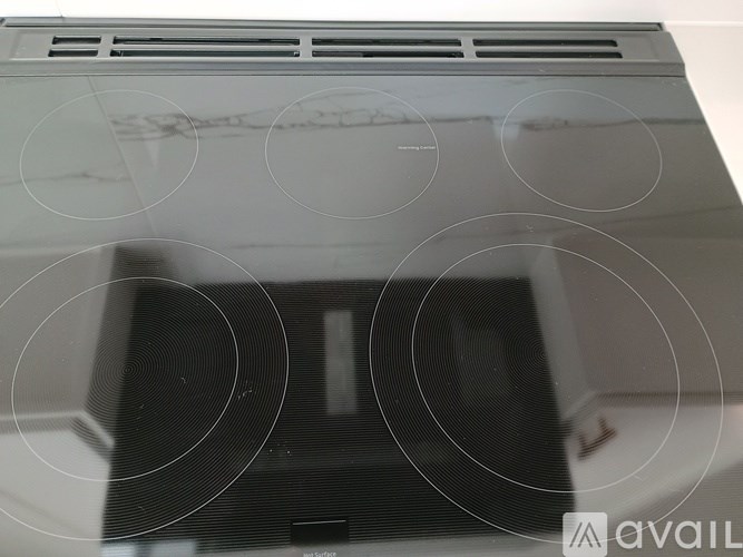 A white air conditioner unit with a black grill.