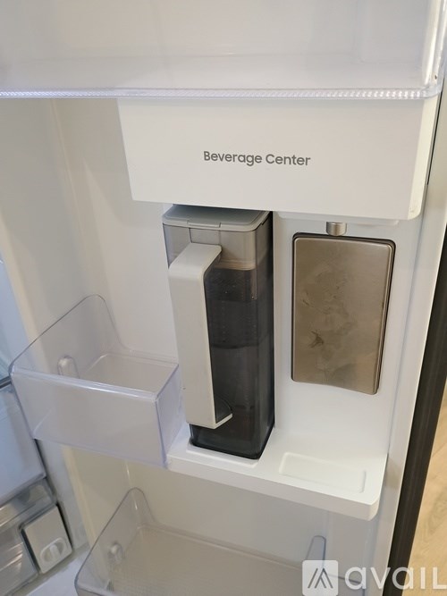A white beverage center with a glass container and a metal container.