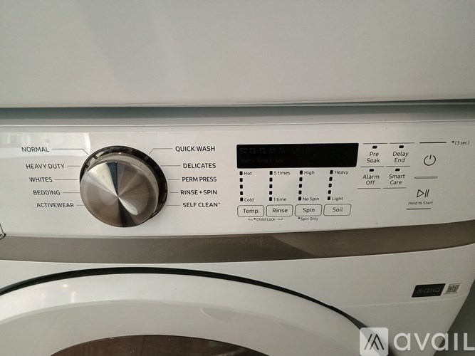 A front load washing machine with the control panel and dials visible.
