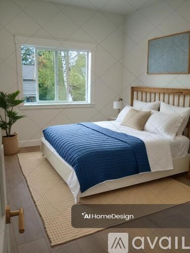 A bedroom with a bed, pillows, and a window.