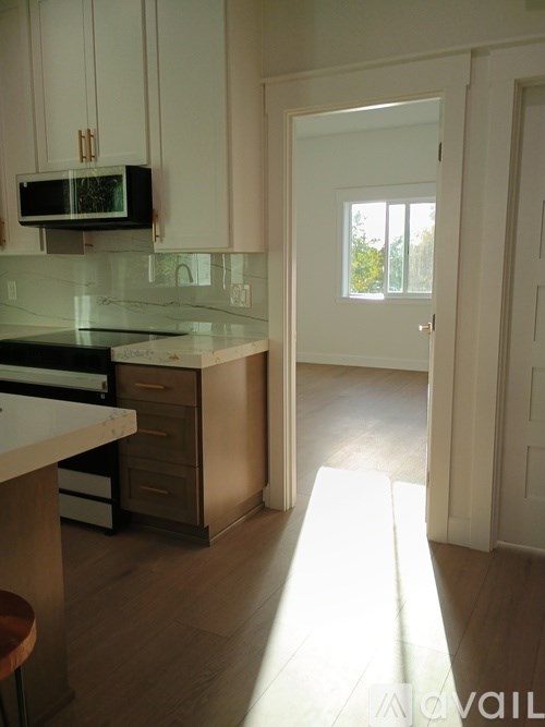 A kitchen with a counter top and a microwave.