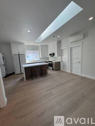 A kitchen with a table and chairs in the middle of the room.