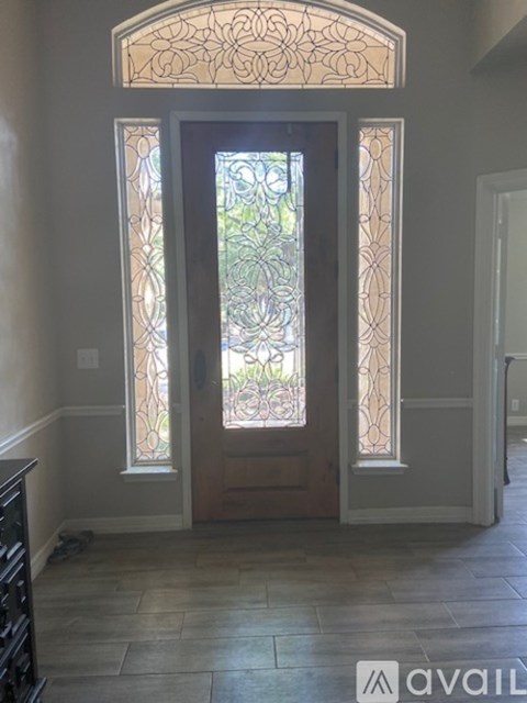 A glass door with a stained glass window in the middle.