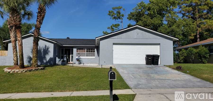 A house with a garage and a mailbox in front.