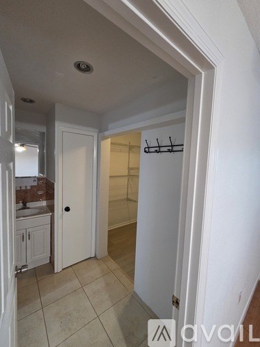 A white bathroom with a sink and a toilet.