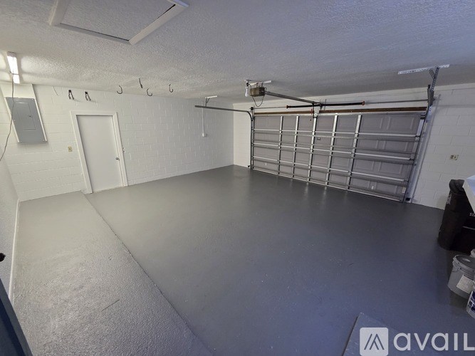 A spacious garage with a grey floor and white walls.