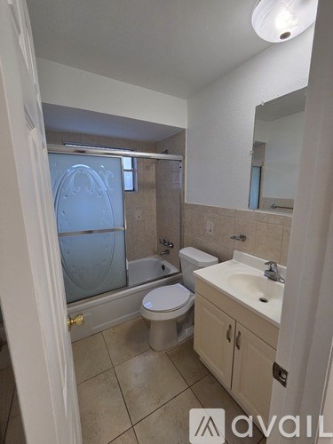 A bathroom with a toilet, sink, and shower.